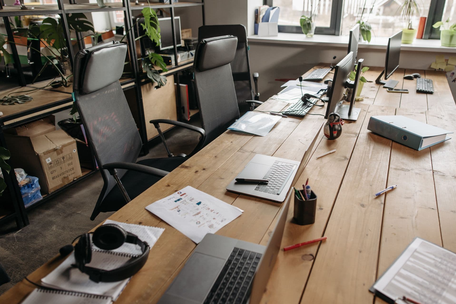 Modern commercial office with desks and laptops